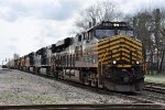 Westbound vehicle train approaches the diamonds behind the NKP heritage unit